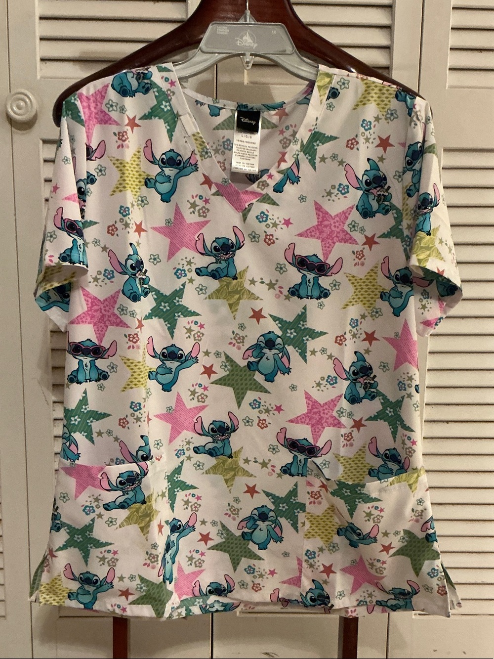 Disney Stitch Women’s White V-Neck Scrub Top with Pink & Green Stars
